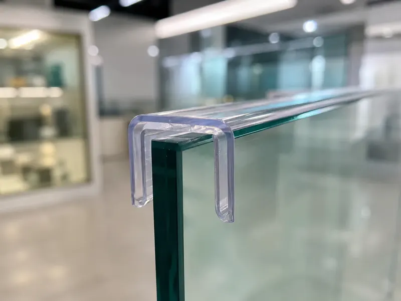 Transparent PVC U-channel installed on a glass panel edge